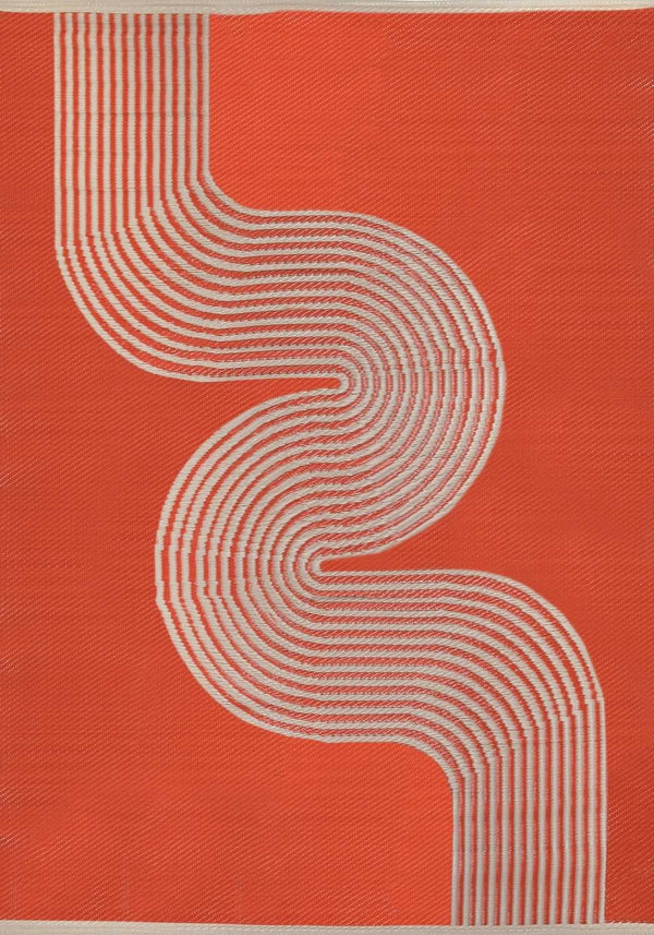 Terra and beige geometric outdoor rug styled on a garden patio