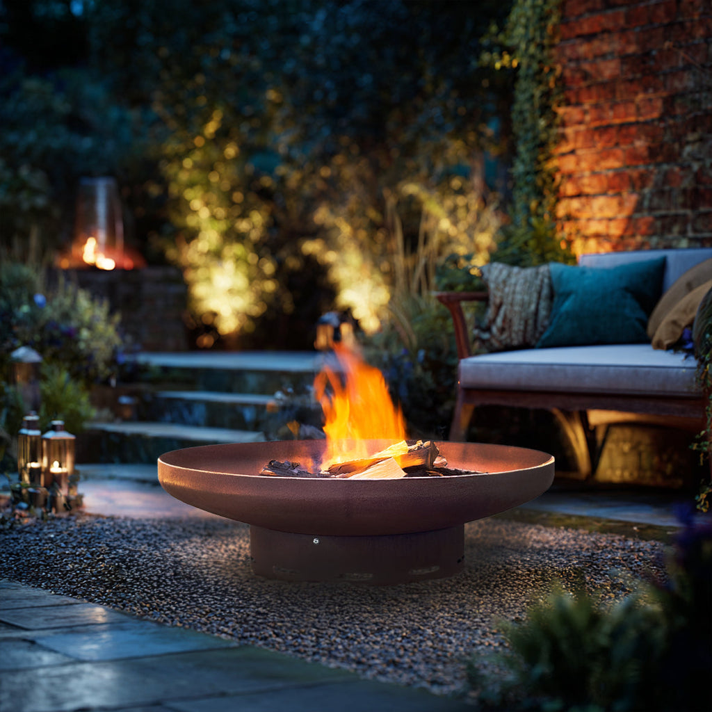 Corten steel fire pit product render showing the round weathering-steel bowl