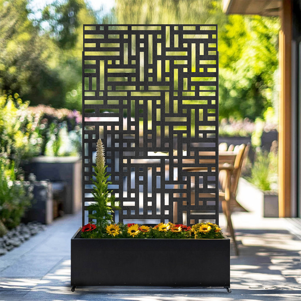 Black metal privacy screen with planter styled with plants in a garden