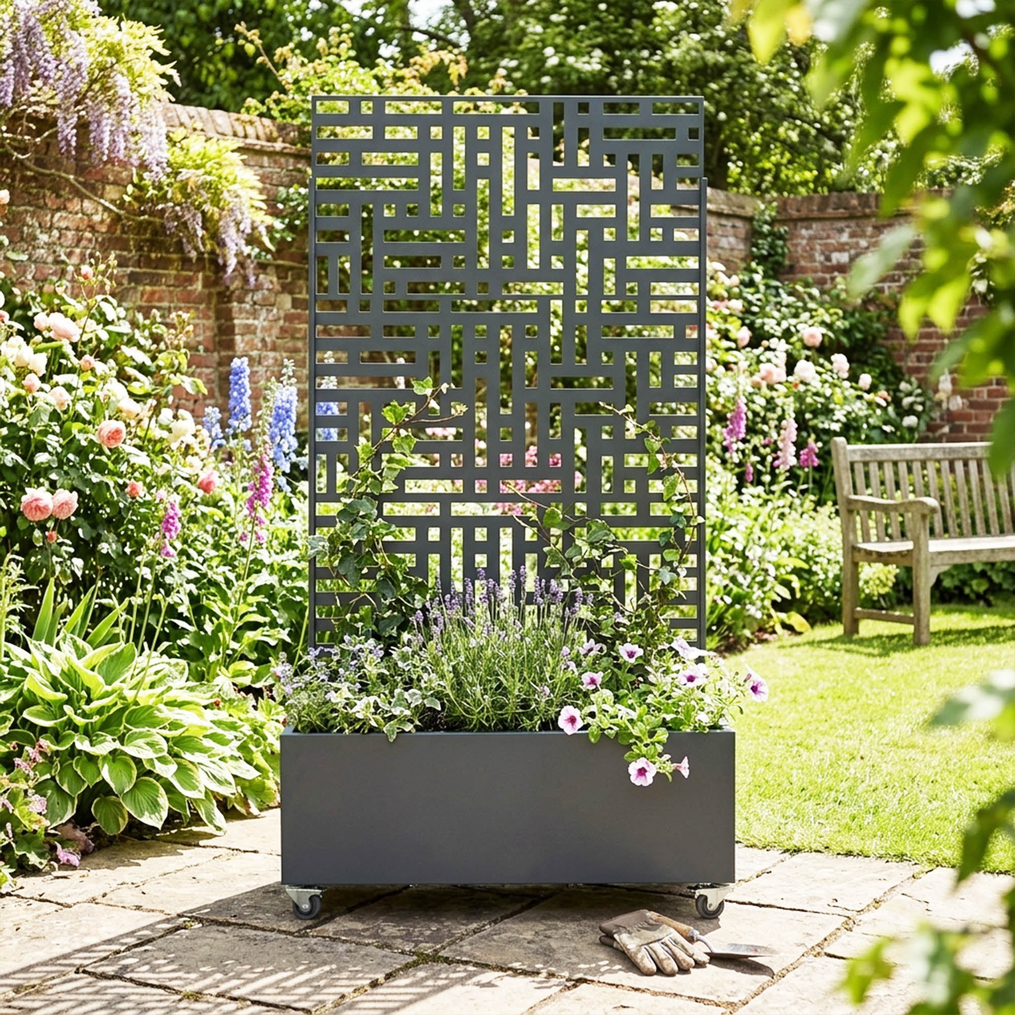 Anthracite grey metal privacy screen with planter in a garden setting