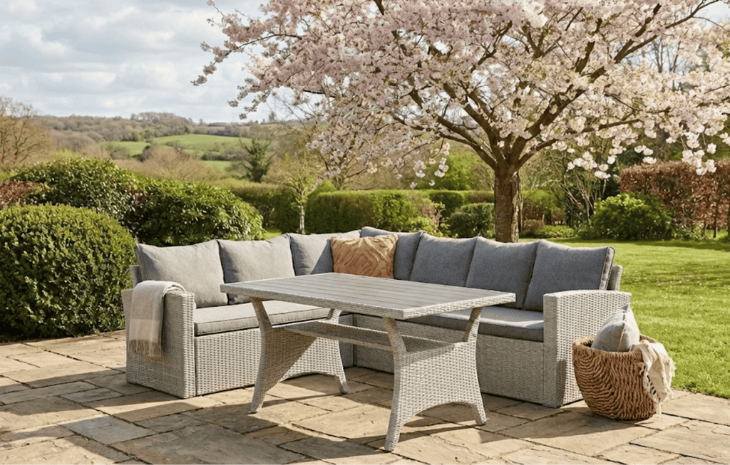 Stockholm 6 Seater Grey Rattan Garden Corner Sofa Set with cover in a British garden