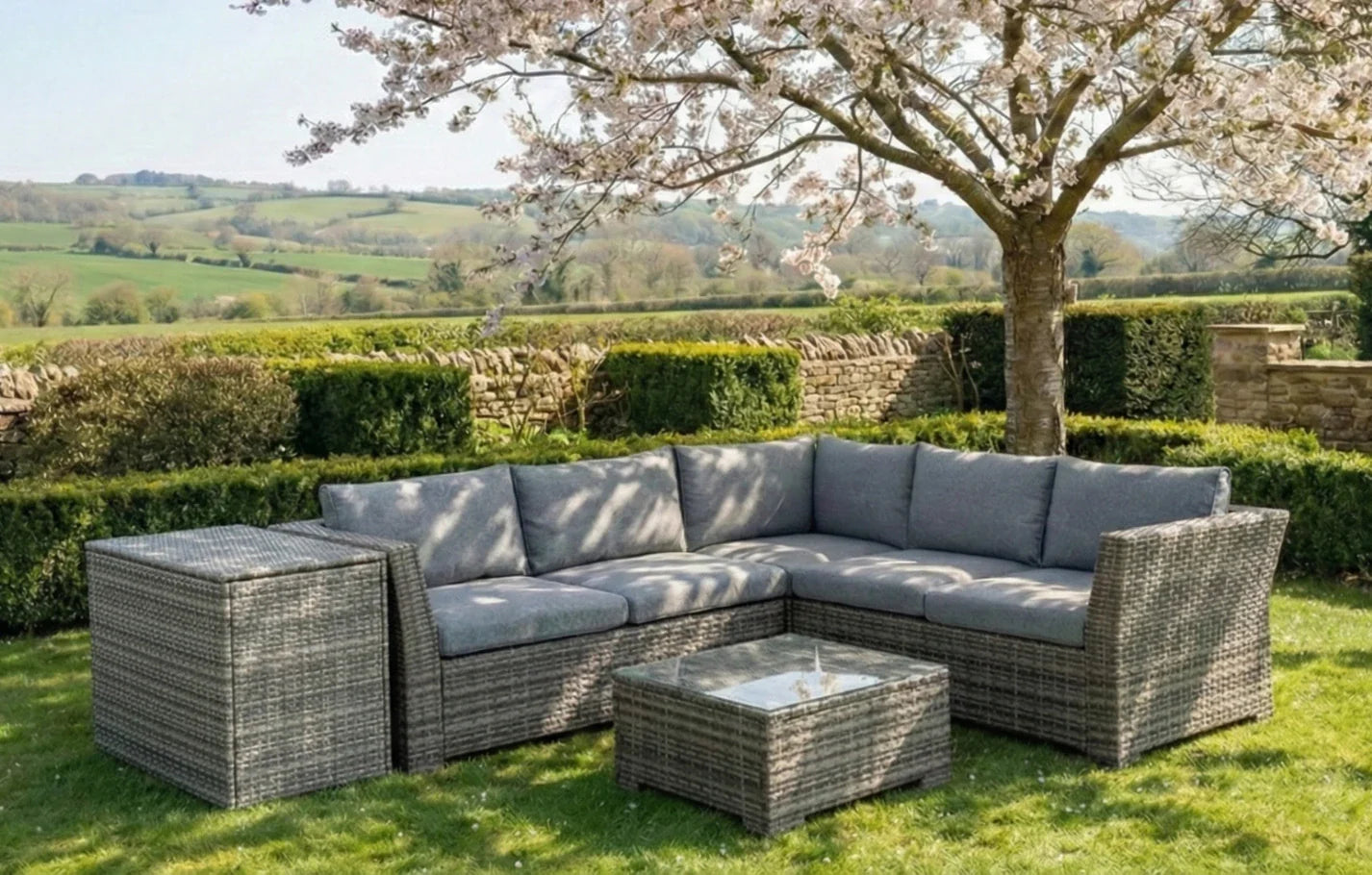 Chesterton Grey 5 Seater Rattan Garden Corner Sofa Set with cushion box in a British garden