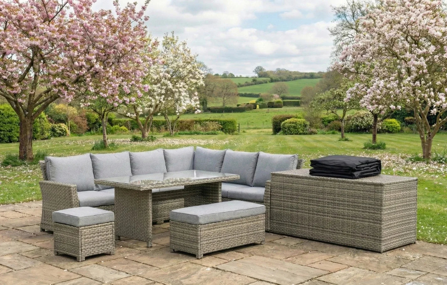 Palma 9 Seater Grey Rattan Garden Corner Lounge Set with cover and cushion box in a British garden